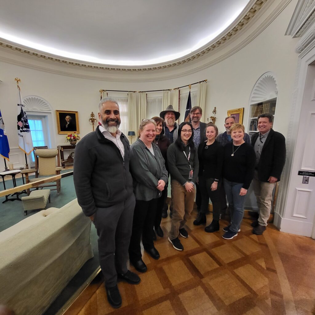 Group photo of Wayfinding Workshop participants in a replica of the Oval Office at the LBJ Presidential Library in Austin, Texas